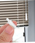 80-Piece Spring Loaded Pins DIY Window Blind Repair Kit With Essential Shutter Hardware For Quick Self Fixes in hand near blinds