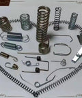 Assorted metal springs including compression, extension, and torsion springs showing diverse shapes and sizes for Rock Solid Six Axis Cnc Wire Spring Machine With Slick Automatic Coiling For Legit Compression Extension And Torsion Spring Fabrication On Your Daily Shop Floor.