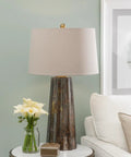 Fluted Obelisk Copper Mercury Glass Table Lamp With Weathered Industrial Finish as a centerpiece on a white side table.