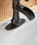 Oil Rubbed Bronze Waterfall Bathroom Sink Faucet With Single Handle 1 Hole Mount No Fuss Easy Install Pop Up Drain Assembly And Durable Supply Hose Farmhouse Vanity Bath Faucet close-up on spout and base.