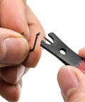 Close-up of Premium Stainless Steel Line Cutter with Ergonomic Handle cutting a fishing hook, ideal for saltwater use.