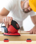 Man sanding wood using tool with 12 Pack Three Quarter Inch Bench Dogs For Woodworking Red Dog Hole Clamps visible on surface