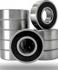 Stack of 6204 2RS Deep Groove Ball Bearings with pre lubricated design and double rubber seals for durable rotational motion in machinery.