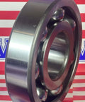 6410 Bearing 50x130x31mm - Open Heavy Duty Deep Groove Ball Bearing angled view on striped background