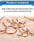 Close-up of 330Pcs Nine Size Spring Hose Clamps Set 5mm To 13mm Galvanized 65Mn Spring Clips on wooden surface