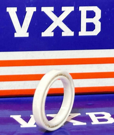 6704 Full Ceramic Bearing 20x27x4mm displayed against a blue and red background, showcasing zirconia ceramic construction.