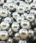 Close-up of .68 Caliber Aluminum Solid Paintballs for self-defense launchers, showcasing 50pcs of shiny silver aerospace aluminum balls.