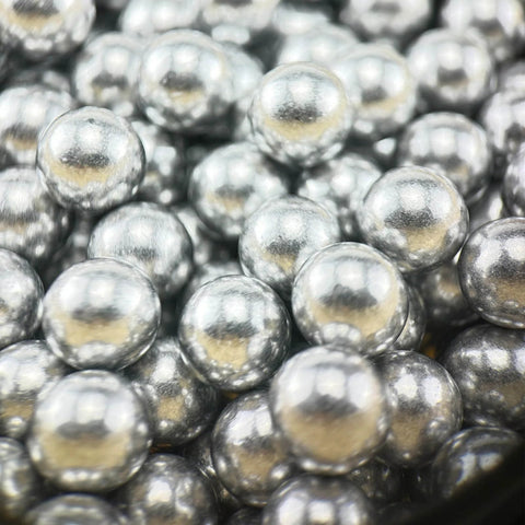 Close-up of .68 Caliber Aluminum Solid Paintballs for self-defense launchers, showcasing 50pcs of shiny silver aerospace aluminum balls.
