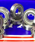 10-Pack 6900ZZ Bearings - 10x22x6mm - Double Shielded Ball Bearings arranged on a reflective surface
