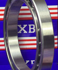 6922 Thin Section Metric Ball Bearing 110x150x20mm Large, chrome steel, deep groove, side view against blue and red packaging