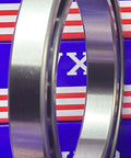 6922 Thin Section Metric Ball Bearing 110x150x20mm Large, chrome steel, side view against blue background