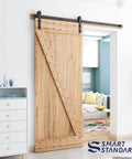 Wooden door with 6ft Barn Door Hardware Kit with I shape hanger, installed in living room, carbon steel track for smooth quiet sliding.