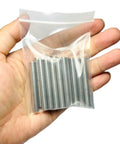 Hand holding a bag of Sturdy 6mm Dowel Pins Set For Shelves And Woodworking 15 Pack 50mm Length 304 Stainless Steel M6 Dowels
