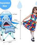 Kids Outdoor Folding Lawn And Camping Chair With Cup Holder And Carrying Bag For Beach And Travel, Sturdy Steel Frame, Water Resistant Oxford Cloth, Cute Shark Pattern displayed next to a child for scale.