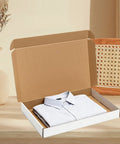 White Corrugated Shipping Boxes 17x11x2 Inches 20 Pack open with shirt inside, ideal for product packaging supplies.