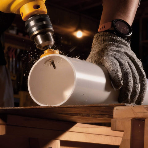 KATA 3-piece impact hole saw set mounted on a yellow drill cutting a white PVC pipe
