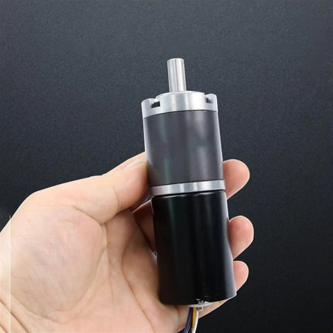 Hand holding Beefy Heavy Duty Planetary Gear Motor With Brushless DC 12V 24V Dual Voltage For Automation And Robotics FG Reverse PWM Speed Control 98 RPM 150 Kg Cm Torque Compact High Torque BLDC Gearmotor For Smart Machines
