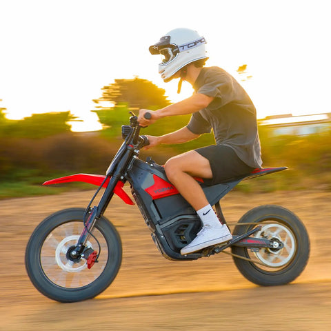 Rider enjoying IN10 Off Road Electric Mini Dirt Bike For Teens And Adults 2600W Motor with removable 1123Wh battery at sunset