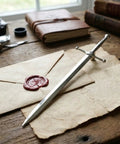 Vintage Sword Style Letter Opener For Envelopes And Mail With Slick Precision Slitter And Ergonomic Silver Handle on desk