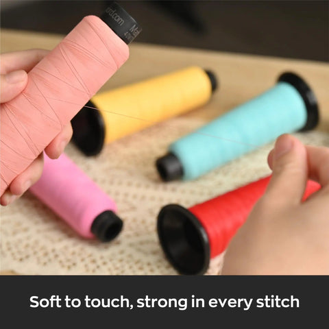 Person holding pink thread spool near Matte Embroidery Thread 40WT Low Sheen Polyester For Embroidery Machines 2500M Spools