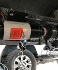 12V Macerator Pump For Boats, RVs, And Yachts - 12 GPM mounted under a vehicle, showcasing heavy-duty construction and self-priming capability.