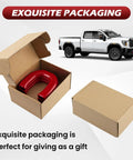 Red Tow Hook Covers for GMC Sierra HD 2500 And 3500 2019 Through 2026 in open packaging next to a white truck.