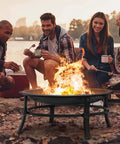 Group enjoying 26 Inch Outdoor Wood Burning Fire Pit Heavy Duty Steel Bonfire Bowl With Spark Screen Log Grate And Poker For Patio Backyard Camping Deck And Picnic Great For Family Gatherings And Chill Sessions