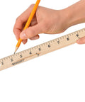 Hand using Go To 36 Inch Wood Yardstick With Dual Sided Scales And Clear Lacquer Finish One And One Eighth Inch Wide for measuring