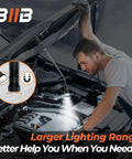 Mechanic uses LED magnetic pickup tool under car hood with flashlight