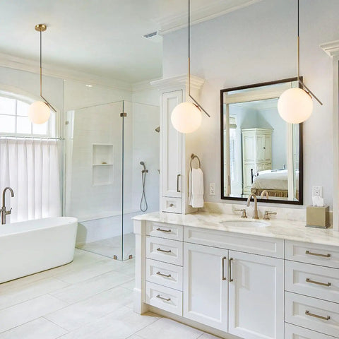Mid Century Modern 1 Light Globe Pendant Chandelier In Brushed Gold With White Glass Ball in a bright bathroom setting