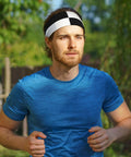 Black And White Piano Grid Print Stretchy Headbands Sweat Wicking And Ultra Breathable Workout Band on a man jogging outdoors.