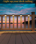 16 Pack Solar Step Lights Waterproof LED Fence Lights For Decks And Stairs Railing Outdoor Lighting All Night On To Brighten Your Yard Gardens Backyard Patio And Balcony Decor illuminating a deck railing at sunset.