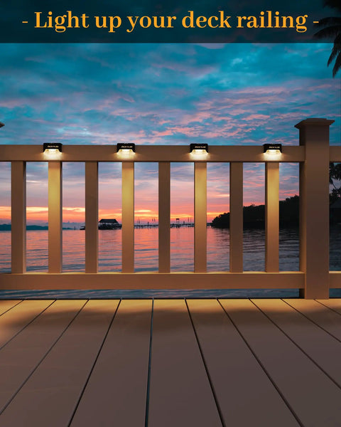 16 Pack Solar Step Lights Waterproof LED Fence Lights For Decks And Stairs Railing Outdoor Lighting All Night On To Brighten Your Yard Gardens Backyard Patio And Balcony Decor illuminating a deck railing at sunset.