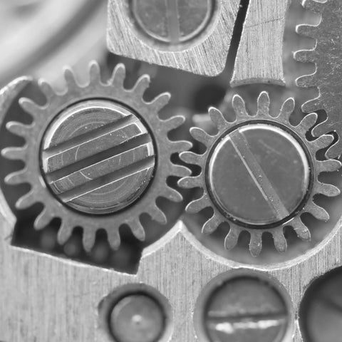 Close-up of stainless steel gears with slotted pins, similar to 15 Pack M4 X 10mm Slotted Cylindrical Pins, 304 Stainless Steel Dowel.