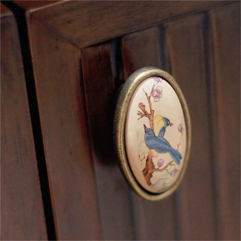 4 Pack Ceramic Cabinet Knob Pulls Set For Cabinets And Dressers, featuring bird design on metal handle on wooden cabinet