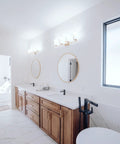 Modern bathroom with wood cabinetry and round mirrors, featuring Solid Core Stainless Steel Cabinet Pulls 5-1/16 Inch Center.