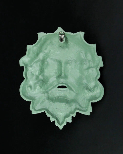 Heavy Duty Cast Iron Celtic Green Man Wall Plaque Sporting A Dead Cool Antiqued Verdigris Finish Standing Ten Inches Tall hanging on a wall.