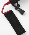 Close-up of strap on Army Leather Heli Ski Glove for Freeriders and Mountain Guides, featuring durable black material and red details.