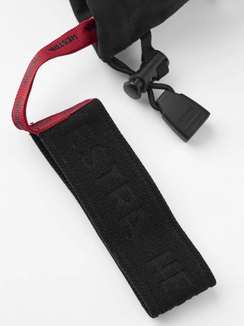 Close-up of strap on Army Leather Heli Ski Glove for Freeriders and Mountain Guides, featuring durable black material and red details.