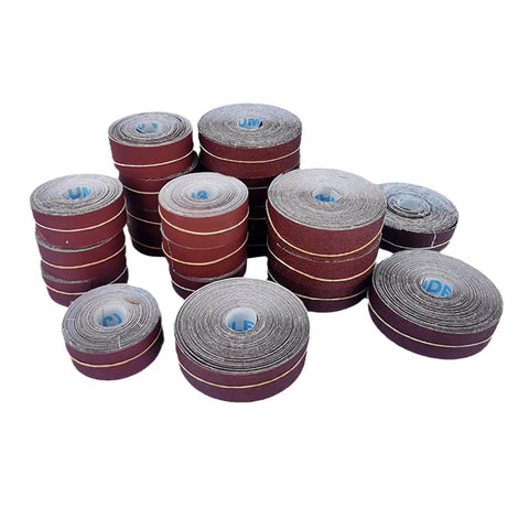 Top Shelf Heavy Duty Emery Cloth Sandpaper Roll For Drum Sanders And Woodworking Bench Projects, various sizes in a stack.