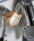 Mini Cellini Espresso Machine With Steam Wand And Pressure Gauge, white paneling, chrome accents, wooden handle, close-up view