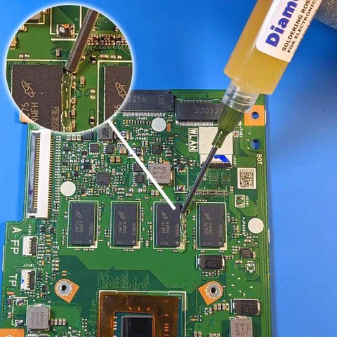 Applying FN231 Top Notch Pro Grade No Clean Soldering Flux Gel RMA ROL0 on PCB with syringe, close-up