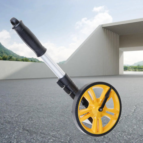 Measuring Wheel 0-9999.9m Digital Display for Construction Worker with a yellow wheel on an outdoor surface.