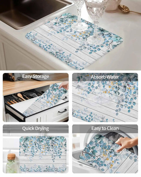 Absorbent Reversible Dish Drying Mat With Hanging Loop For Kitchen Counter In Eucalyptus Leaves Blue Farmhouse Wood Grain Microfiber Quick Dry 16 By 18 Inches Machine Washable Easy To Hang Or Store shown with glasses on it, in storage, drying and cleaning closeup.