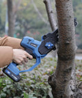 Person using 8 Inch Cordless Mini Chainsaw With Dual 2000mAh Batteries Electric Handheld Tree Trimmer for yard work on tree branch
