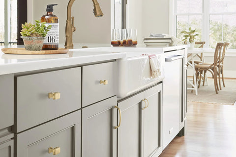 Kitchen with Champagne Bronze Revitalize Cabinet Pull 5-1/16 Inch Center to Center Drawer Pulls on gray cabinetry