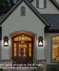 Two Pack Solar Motion Sensor Outdoor Wall Lanterns For Dusk To Dawn Porch Lighting on house exterior by entryway at night