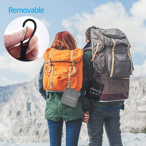 Hikers with backpacks displaying 2 Pack Travel Laundry Bags With Handles And Aluminum Carabiner Dirty Clothes Organizer on mountain trail