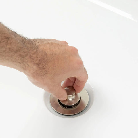 Hand operating lift and turn bathtub drain in oil rubbed bronze, part of Lift And Turn Bathtub Drain Assembly Conversion Kit With Single Hole Overflow Face Plate In Oil Rubbed Bronze All Brass Construction Durable Tub Stopper Easy Tap Open Close For Smooth Bathing.