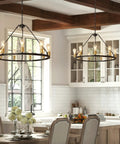 Black And Gold 9 Light Industrial Wagon Wheel Farmhouse Chandelier hanging in modern kitchen with white cabinets